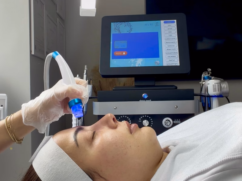 A facial handpiece being used during a BioHydra Glow treatment